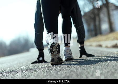 detail of shoes of an athlete simulating starting blocks on the street Stock Photo