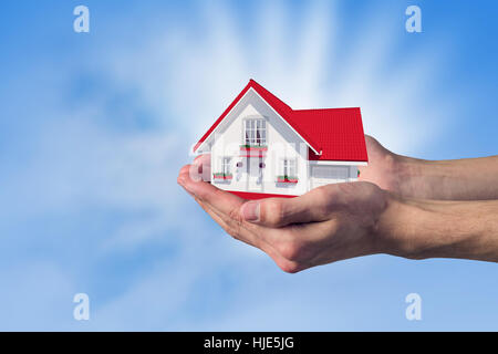 Human hands holding model of dream house Stock Photo - Alamy