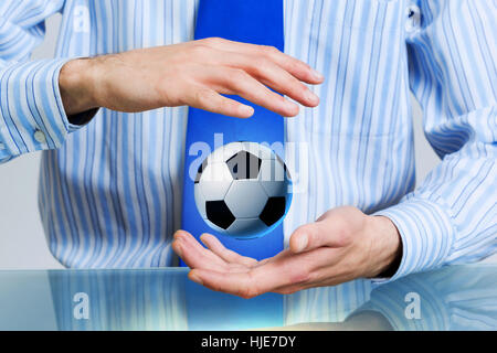 Hands of businessman holding with care soccer ball Stock Photo - Alamy