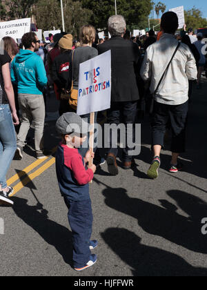 A young boy holds a protest sign at the Women's March in Los Angeles, CA on January 21st, 2017 Stock Photo