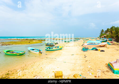 A local fishing village with anchored fishermen's boats on the beach is seen along the northern coast in Point Pedro. Horizontal Stock Photo