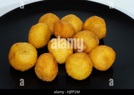 Thai snack, fried potato balls on black plate.jpg Stock Photo