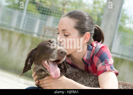 shelter keeper loves her residents Stock Photo