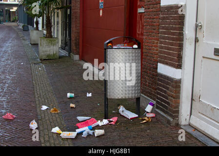 Overloaded trash bin in a street in the dutch city Haarlem Stock Photo