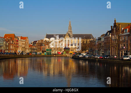 The charming, medieval city Haarlem in North Holland with the Saint Bavo Cathedral, seen from the frozen river Spaarne Stock Photo