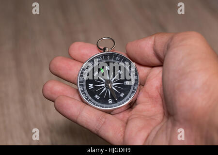 Compass and point to North on hand. Stock Photo