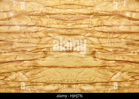 Texture of gold old crumpled fabric macro Stock Photo