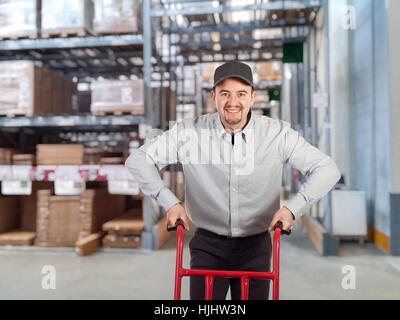 caucasian delivery man in warehouse Stock Photo