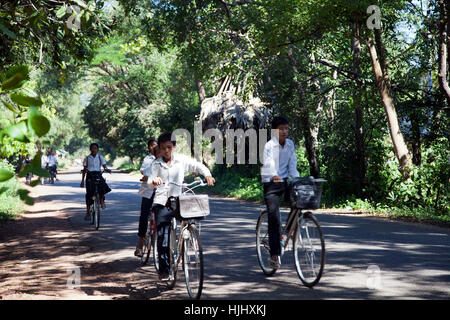 School Kids on Bikes in Siem Reap - Cambodia Stock Photo