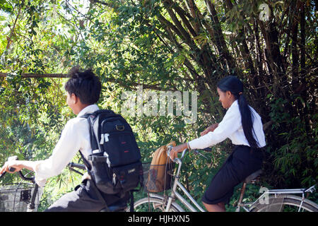 School Kids on Bikes in Siem Reap - Cambodia Stock Photo