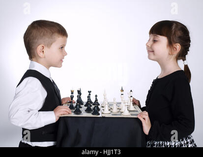 boy and girl playing chess Stock Photo