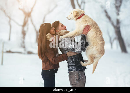 Young couple having fun in winter park Stock Photo