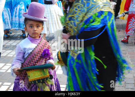 A little girl dressed up in traditional costumer ready to perform in the religious festival, Plaza de Armas, Cusco, Peru Stock Photo