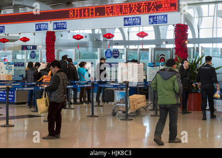 Check-in desks and passengers at Yinchuan Hedong International Airport, Ningxia province, China Stock Photo