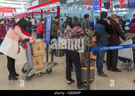 Passengers at check-in desk at Yinchuan Hedong International Airport, Ningxia province,,China Stock Photo