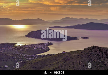 Sunset at Perdika village and Moni islet in the Aegina island located in the Saronic gulf, near Athens, Greece Stock Photo