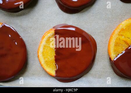 Making candied orange slices dipped in dark chocolate Stock Photo