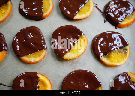Making candied orange slices dipped in dark chocolate Stock Photo