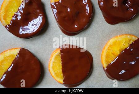 Making candied orange slices dipped in dark chocolate Stock Photo