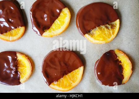 Making candied orange slices dipped in dark chocolate Stock Photo