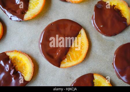 Making candied orange slices dipped in dark chocolate Stock Photo