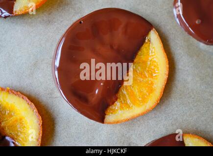 Making candied orange slices dipped in dark chocolate Stock Photo