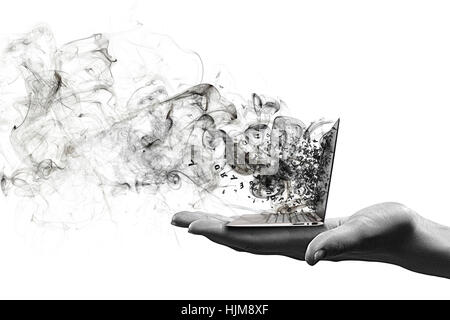 Human hand holding burning laptop on palm Stock Photo