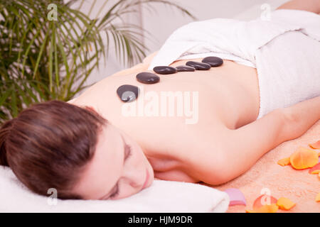 attraktve young woman gets a hot stone massage for relaxing Stock Photo