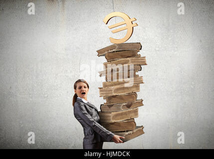 Young businesswoman carrying pile of old books Stock Photo - Alamy