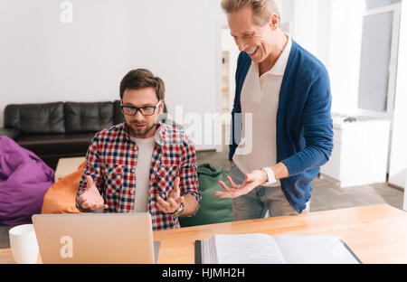 Young brunette man working on the laptop Stock Photo