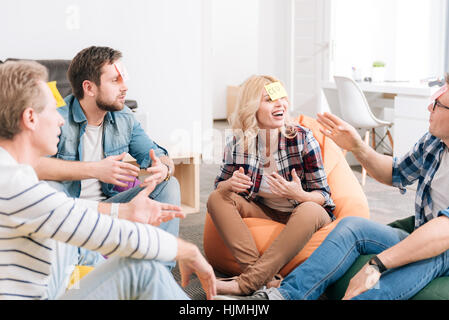 Joyful delighted group of office workers playing a game Stock Photo