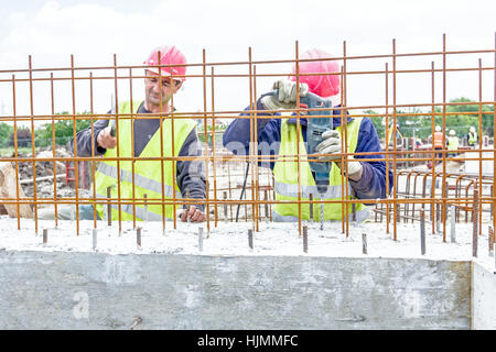 Zrenjanin, Vojvodina, Serbia - May 29, 2015: Construction worker is drilling reinforced concrete in building foundation slab. Stock Photo