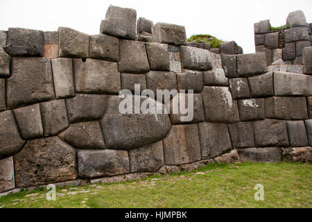 Human built stone wall using no mortar.  No cracks between the stone fitting perfectly and each stone fits precisely to the othe Stock Photo