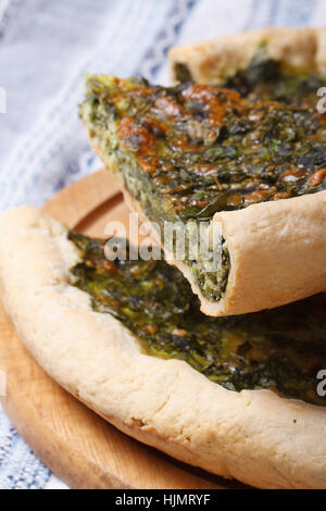 sliced pie with spinach and soft cheese on the table macro. vertical Stock Photo