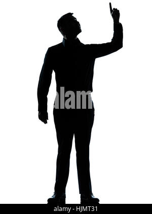 one caucasian business man poiting up happy  silhouette standing Full length in studio isolated on white background Stock Photo