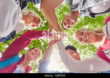 Students giving each other a High Five as symbol of togetherness Stock Photo