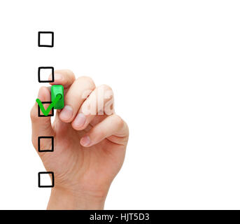 Hand putting check mark with green marker on blank survey checklist on transparent glass board. Stock Photo