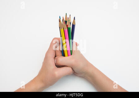 Female hand clenched in a fist dozen pencils Stock Photo