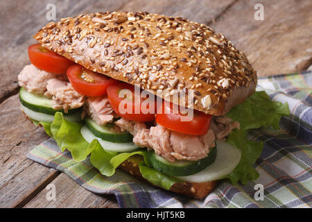 Healthy and tasty sandwich with tuna and vegetables closeup on old table. horizontal Stock Photo