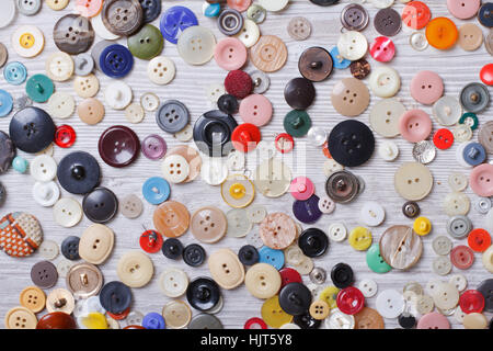 Background of old buttons on wooden board closeup horizontal top view Stock Photo
