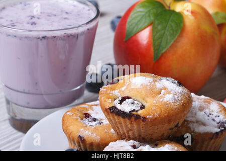 blueberry muffins, fresh peaches and a milkshake closeup on a wooden table. horizontal Stock Photo
