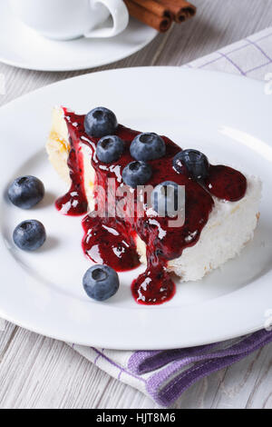 Blueberry cheesecake with berry sauce closeup on table top view vertical Stock Photo