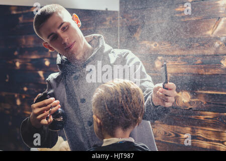 Little Boy Getting Haircut By Barber Stock Photo