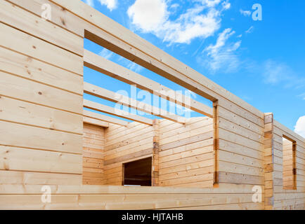 Construction of a new wooden house against the blue sky background Stock Photo