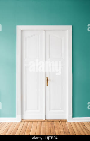 mint green walls and wooden door in apartment / home interior Stock Photo