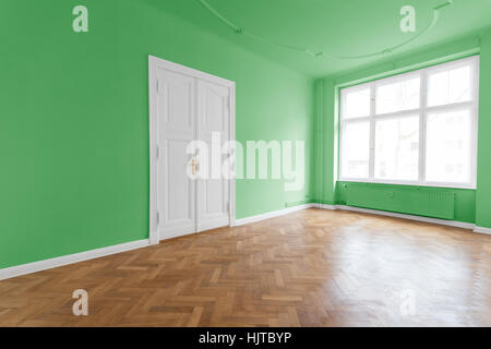 room with green walls and parquet floor Stock Photo