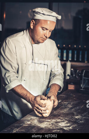 Busy chef at work in the restaurant kitchen Stock Photo