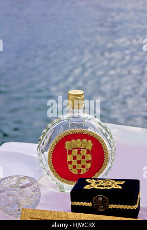 Bottle of croatian domestic brandy - rakija Slivovitz  by the sea Stock Photo