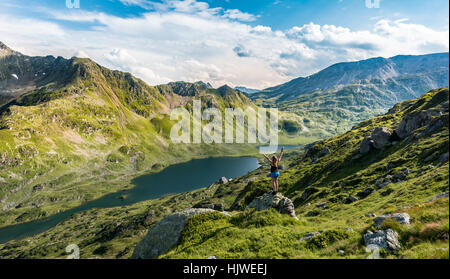 Hiker stretching arms in the air, mountains, Low Giglachsee, Rohrmoos-Obertal, Schladminger Tauern, Schladming, Styria, Austria Stock Photo