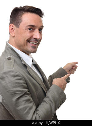 Businessman pointing to copy space. Handsome young man in jacket looking at camera and pointing away while standing against white background Stock Photo